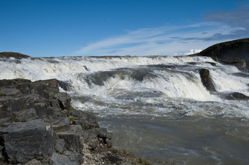 Typical Icelandic landscape of Gullfos Falls, a wild nature of rocks and shrubs.