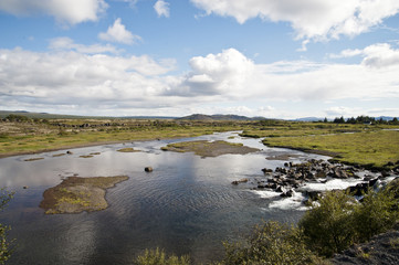Typical Icelandic landscape, a wild nature of rocks and shrubs, rivers and lakes.