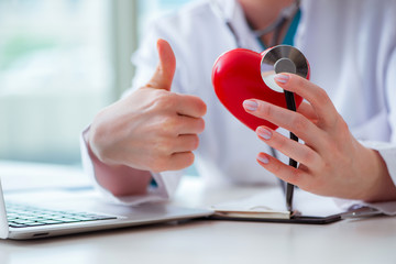 Doctor checking up heart in medical concept