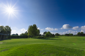 General view of a green golf course on a bright sunny day. Idyllic summer landscape. Sport, relax, recreation and leisure concept