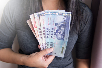 Hands woman show new Taiwan dollar bills,Toned picture