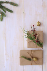 Christmas gift boxes and fir tree branch on wooden table, flat lay. Сhristmas background