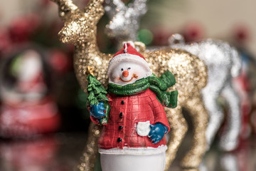 Small Christmas ornaments arranged into a holiday festive scene
