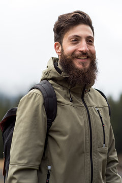 Hipster Adventurer hikes along Lake Obernberg in the mountains of Austria