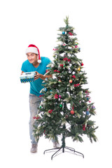 Young man decorating christmas tree isolated on white