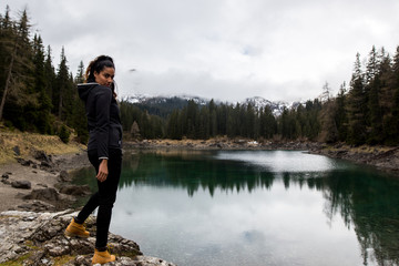 Fototapeta na wymiar Girl hikes along Lake Obernberg in the mountains of Austria