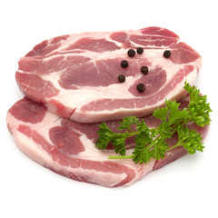 Raw pork neck chop meat with parsley herb leaves and peppercorn spices garnish isolated on white background cutout