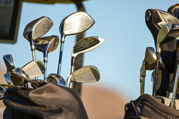 Two golf bags with clubs