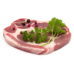 Raw pork neck chop meat with parsley herb leaves and peppercorn spices garnish isolated on white background cutout