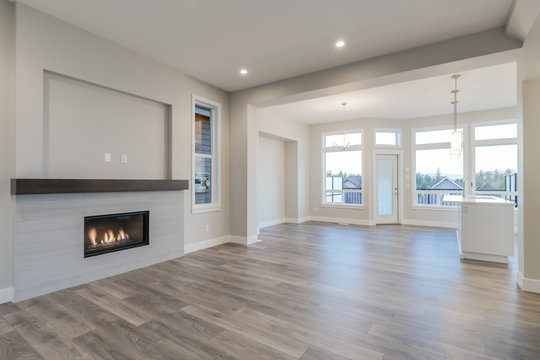 Interior of a modern living room with hardwood floors and fireplace.