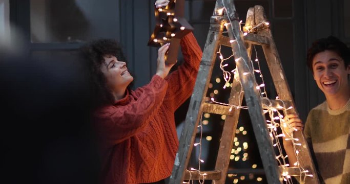 Couple decorating an alternative christmas tree