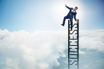 Businessman slipping from the top of ladder