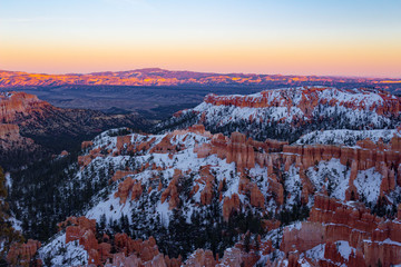 Colorful snowy Bryce Canyon National Park during sunset in Utah.