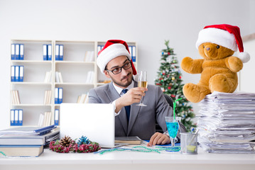 Young businessman celebrating christmas in the office