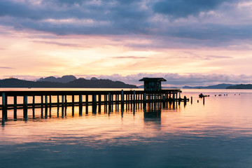 Fototapeta na wymiar scenery view of old jetty to the sea beautiful sunrise or sunset dramatic sky in phuket thailand