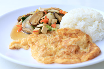 Stir Fried Tofu in Chinese Style,Stir fried tofu with mixed vegetables and fried egg in white plate with rice on white background for celebrate Chinese new year festival,Vegetarian Food, healthy food.