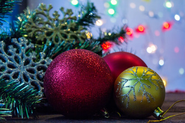 New year and Christmas.Christmas toys and twigs of Christmas tree on wooden table