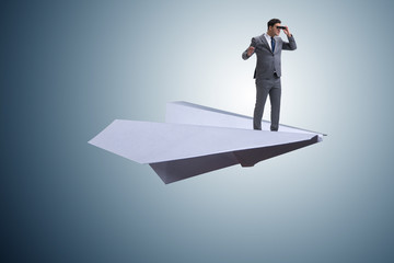 Obraz premium Businessman flying on paper plane in business concept