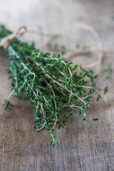 Thyme bunch. Bundle of fresh thymes on a wooden background