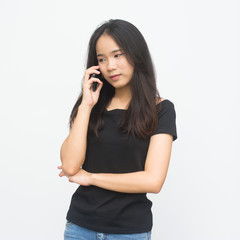 Happy asian young girl talking on a phone isolated on white background..