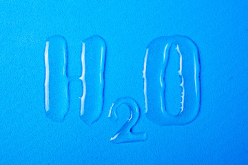 H2O letters and numbers are written with spilled clean water