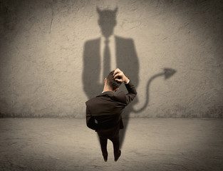 Salesman facing his own devil shadow