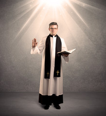 young priest in giving his blessing