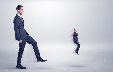 Fototapeta premium Small man fired by boss with white wallpaper