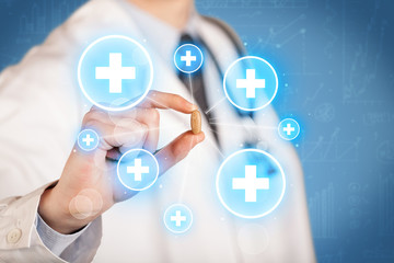 A doctor showing a pill with crosses