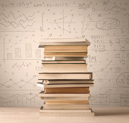 A pile of books with math formulas written in doodle style