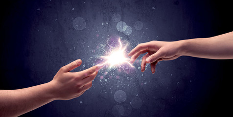 Hands reaching to light a spark