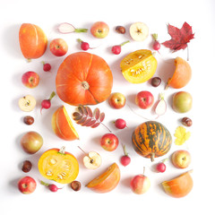 Autumn concept. Pumpkin, autumn leaves, persimmon, red and green apples on a white background. Pattern of fresh vegetables. Top view, flat layout.