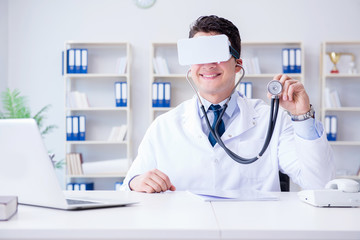 Young doctor with vr virtual reality headset working in the offi