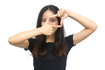 Attractive young asian girl using her hands to create a border around her face isolated on white background