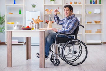 Disabled young man husband working in kitchen