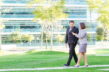 Relaxed Business Man and Woman Walking Outdoors