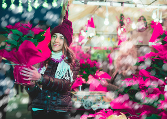 Girl buying Christmas floral compositions