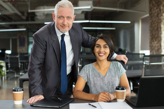 Confident boss working with ambitious intern