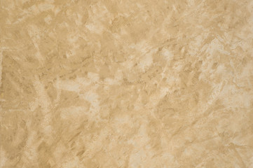 background of the plastered texture with marble effect gold color. artistic background handmade