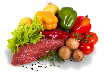 Piece of raw beef, tomato, mushrooms, lettuce, dill, onion, bulgarian and black pepper isolated on white.