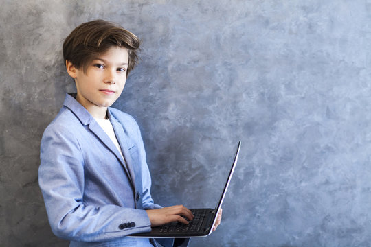 Teen boy holding laptop