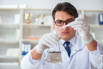Young researcher scientist doing a water test contamination expe