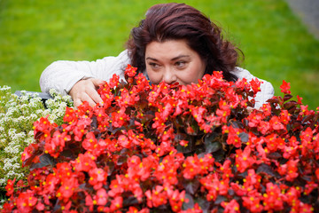 A middle-aged american woman at a flower exhibition in a European small town. A simple woman and simple hobbies housewives