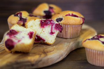 Muffins with cherry and chocolate on a wooden board. Closeup