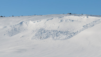 An avalanche of snow came down from the hill.