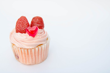 Delicious strawberry cupcakes with heart-shaped jelly are perfect for Valentine's Day backgrounds.