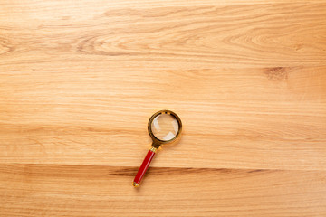 magnifying glass on the wooden background