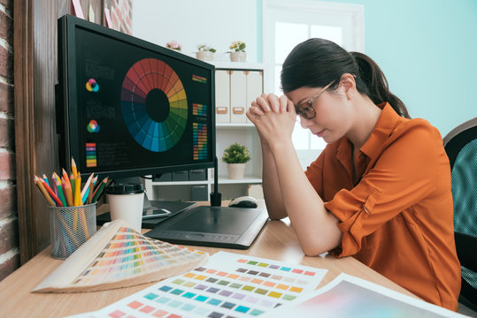 female graphic designer sitting in office relaxing