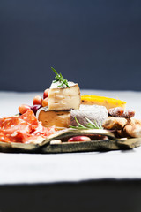 Food tray with charcuterie assortment, cheese  and grapes