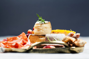 Food tray with charcuterie assortment, cheese  and grapes